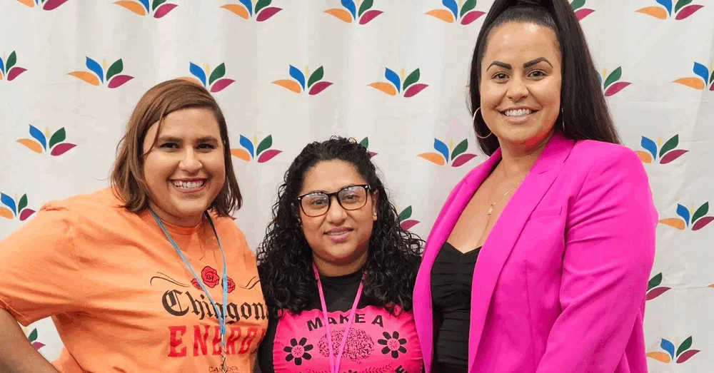 Julia Garrido with two women at a community event